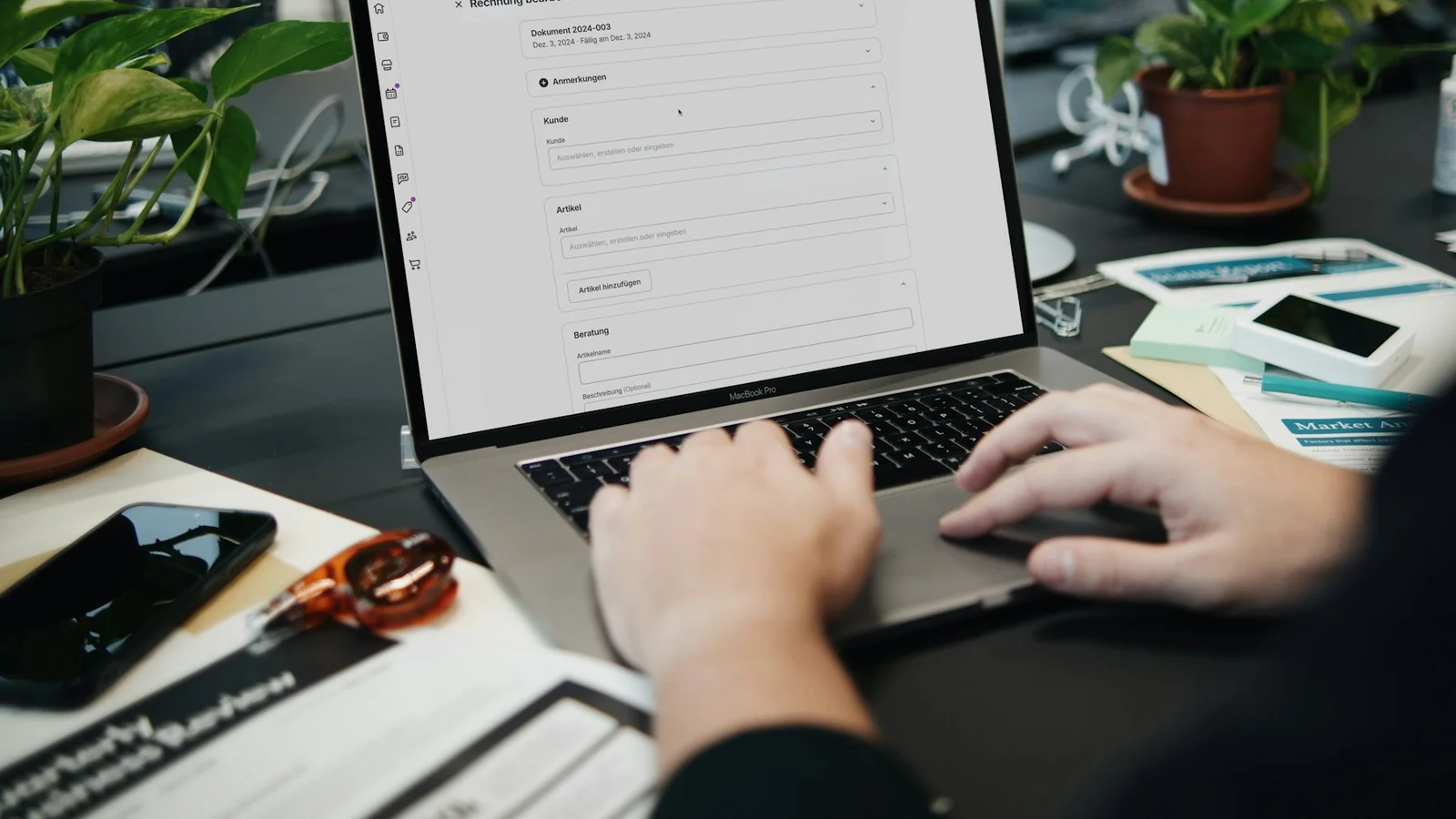 A freelancer reviewing documents on a laptop, illustrating invoice and tax-record management